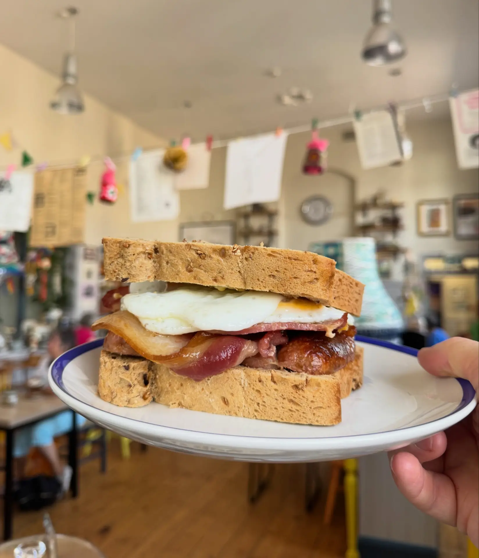 Breakfast sandwich on a blue-rimmed plate
